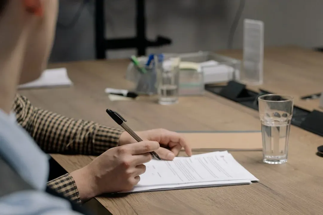 A business professional reviews and signs company incorporation documents