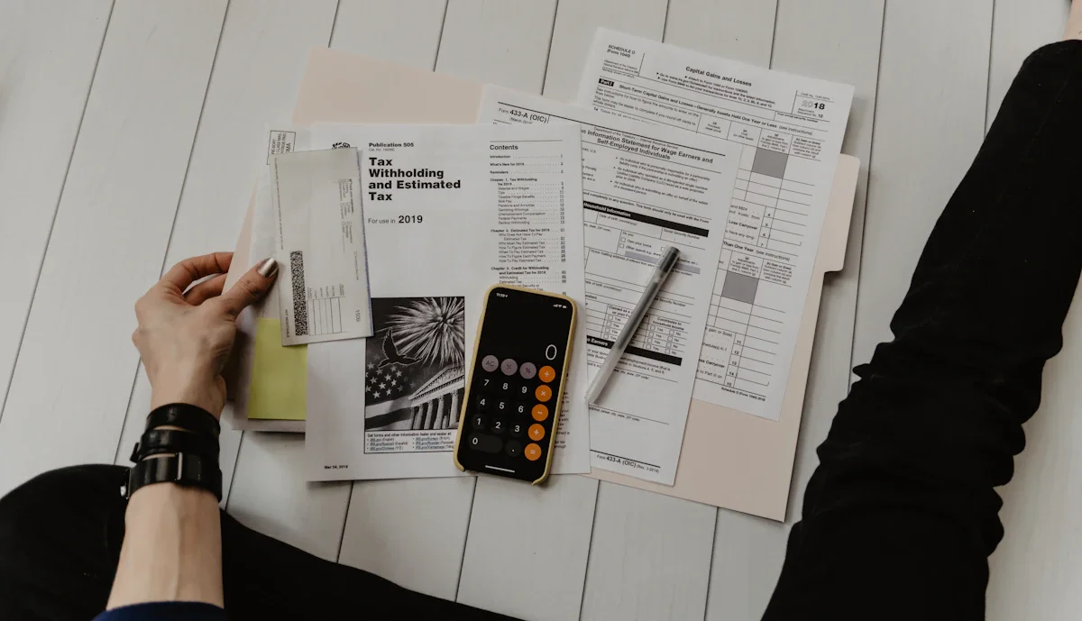 An accountant reviewing audited financial statements and a tax computation document — the Profits Tax Return must be filed with audited accounts signed by a Hong Kong CPA, unlike the Annual Return which contains no financial data