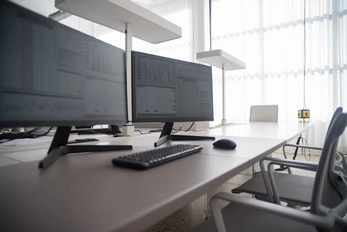 Digital workspace with multiple screens showing company compliance documents accessible online