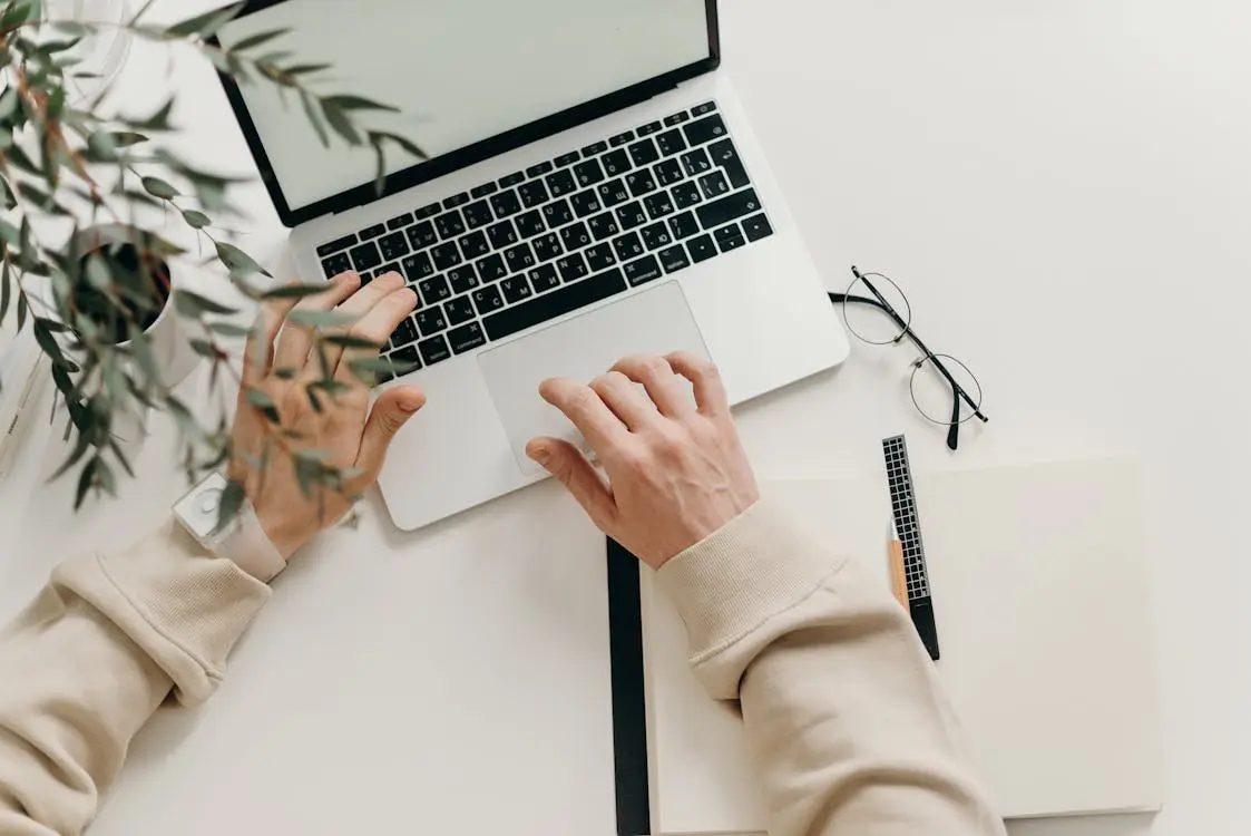 Person working remotely on a laptop, managing a Hong Kong company from abroad