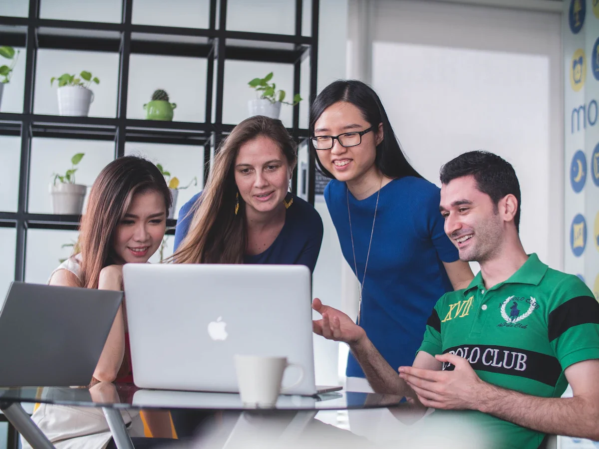 Hong Kong employees working in a modern office — all are covered by the Minimum Wage Ordinance regardless of employment type, hours, or whether they are on probation